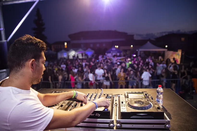 In consolle davanti al pubblico di un festival al tramonto